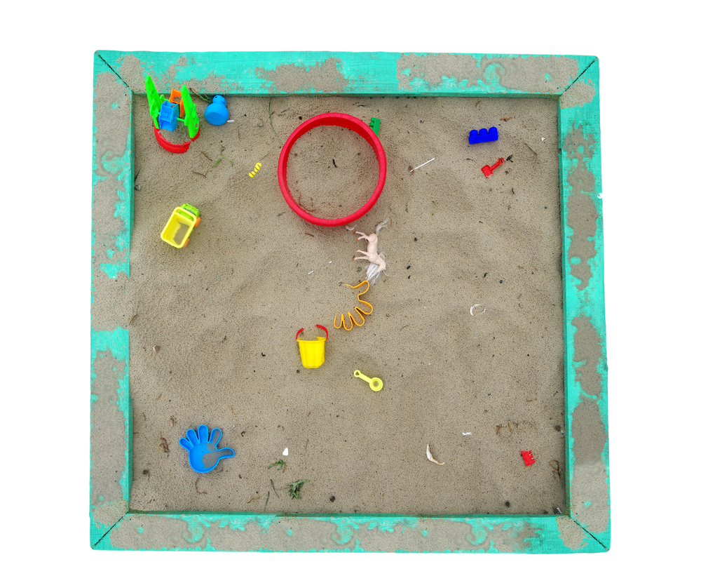 Set of color plastic toys on a sand
